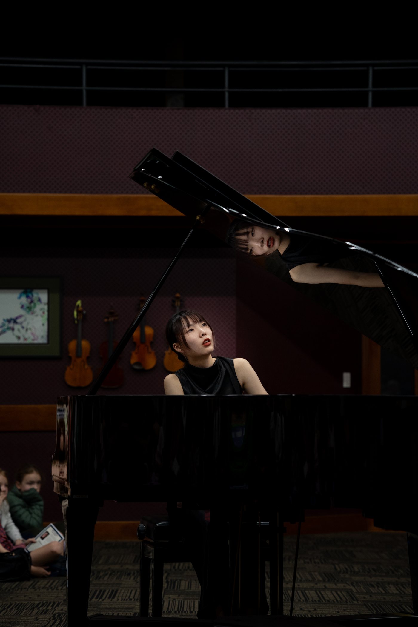 A soloist reflected in the lid of the piano
